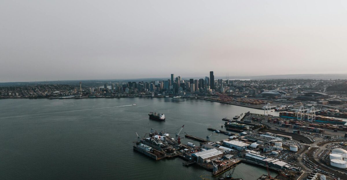 Aerial photography of Seattle s bustling harbor and skyline under a gloomy sky