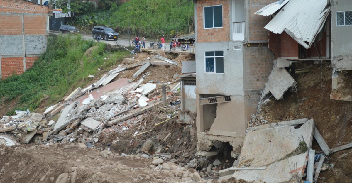 A residential building partially collapsed due to a natural disaster showcasing severe structural damage