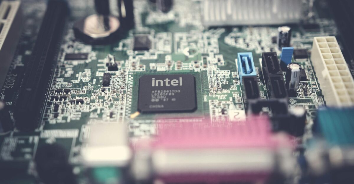 Detailed image of a computer motherboard highlighting an Intel chip with surrounding components