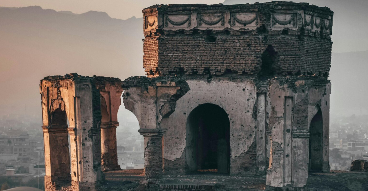 Aged ruins of King Nader Shah's tomb with a backdrop of Kabul city at dusk, displaying rich history.