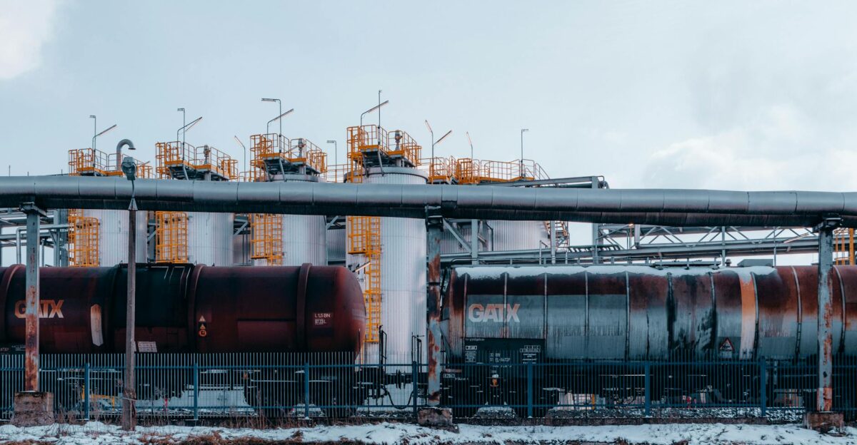 A winter scene of trains and industrial tanks in Trzebinia Poland highlighting the energy sector