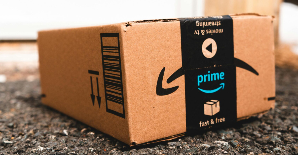 A cardboard box marked with Prime logo placed outside on a porch, ready for delivery.