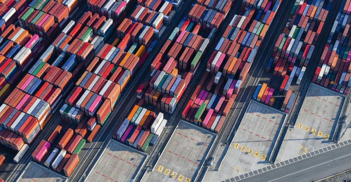 Aerial shot of colorful cargo containers at a bustling New York port showcasing global trade