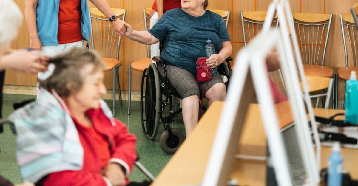 Healthcare professionals interact with elderly individuals in a care facility