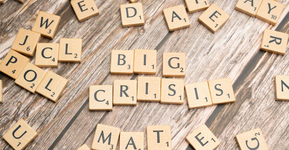 Wooden tiles forming the words Big Crisis on a wooden background
