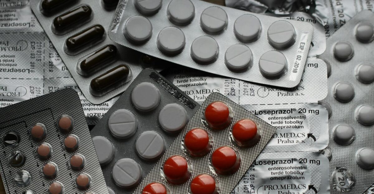 Close-up of various pills in blister packs showcasing medical and healthcare themes