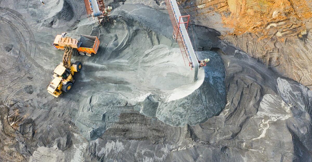 A top-down view showcasing mining operations with excavators and conveyor belts