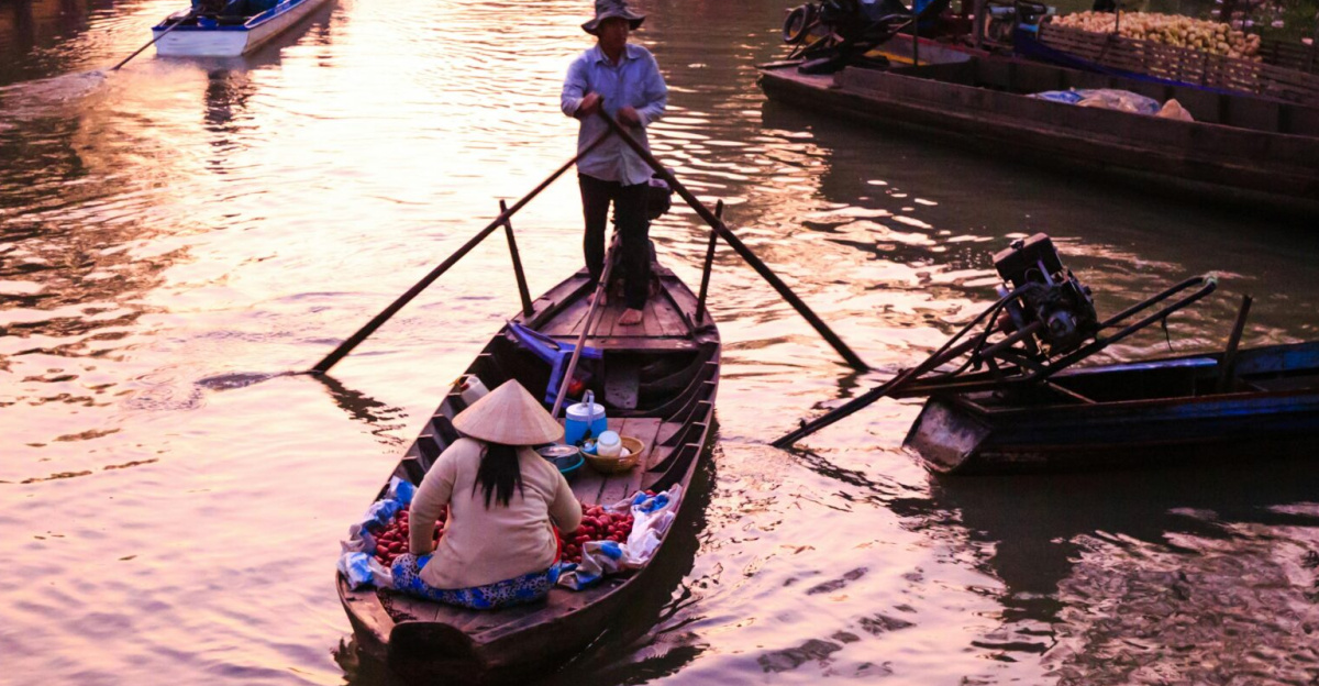 A lively canal market with boats and merchants at sunrise, creating a serene atmosphere.