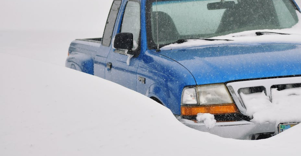 A blue pickup truck buried in snow during a severe winter storm in Lusk Wyoming