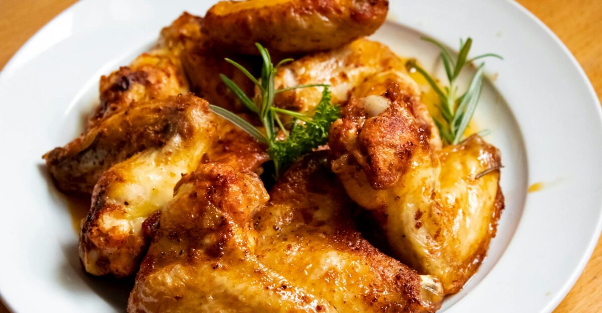 Golden-brown chicken wings garnished with fresh herbs perfect for a tasty meal