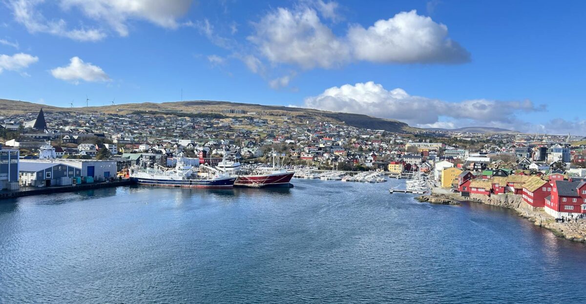 Scenic view of T rshavn harbor and cityscape with ships on a clear day
