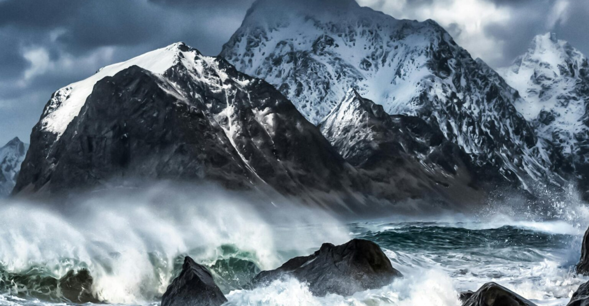 Captivating stormy seascape with rugged Lofoten mountains and crashing waves in winter.