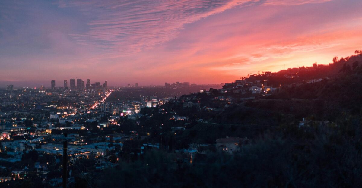 Capture of the vibrant Los Angeles skyline under a dramatic sunset sky