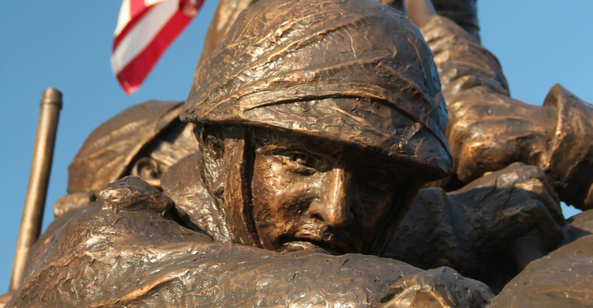 Bronze statue depicting soldiers raising the American flag.