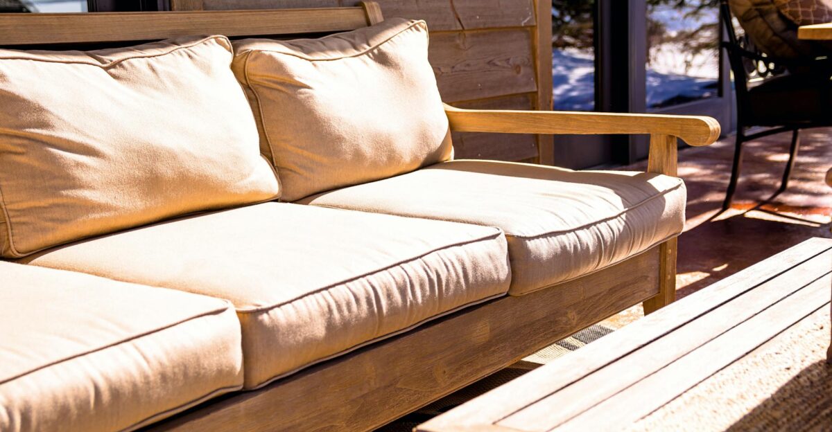 A comfortable outdoor patio seating area with cushions offering a cozy and modern touch to any home