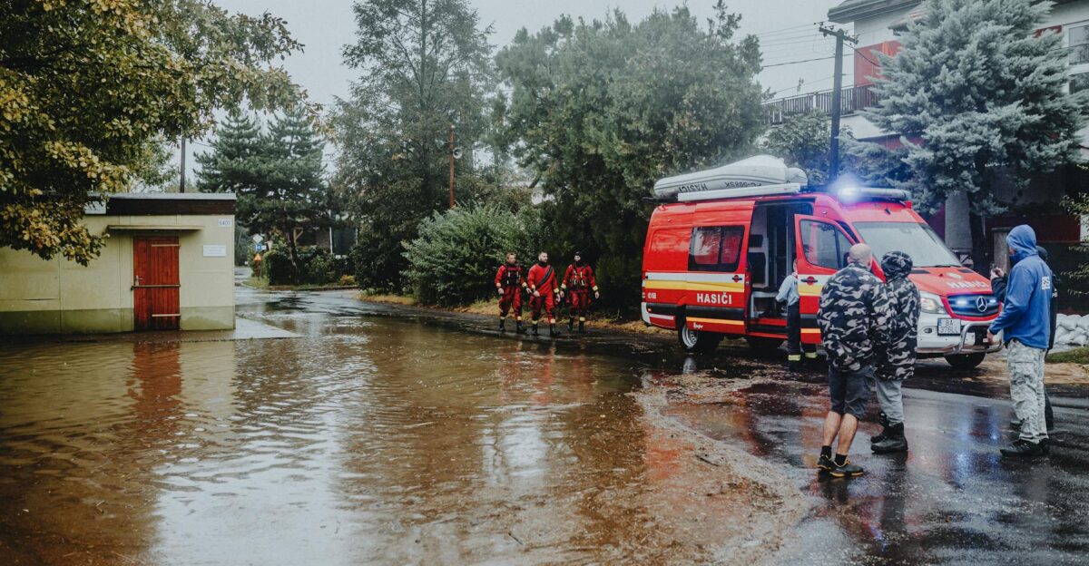 Emergency personnel managing flood with rescue vehicle Urban scene with standing water