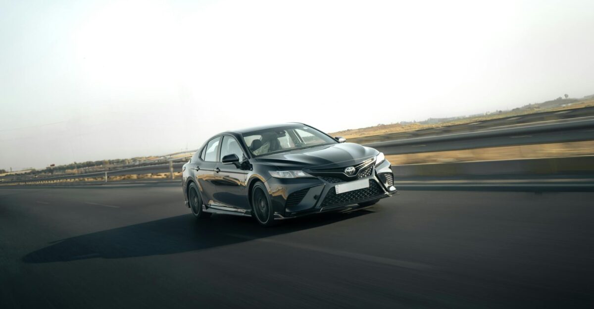 A sleek Toyota Camry in motion on a highway capturing the essence of speed and style
