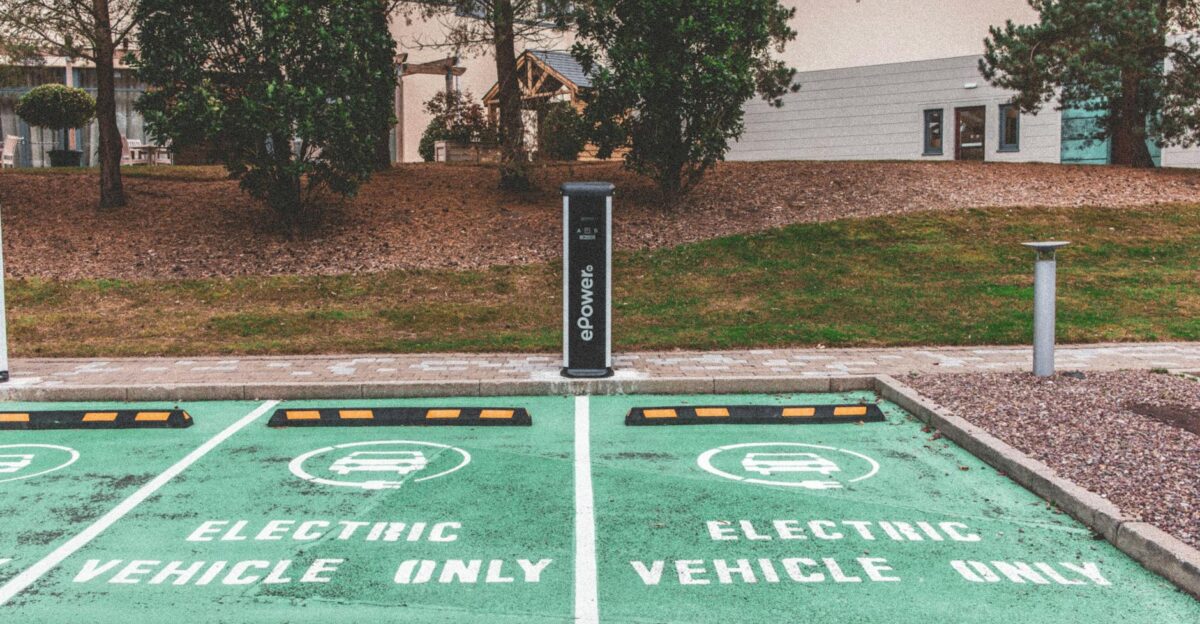 Green electric vehicle parking with charging station in urban environment