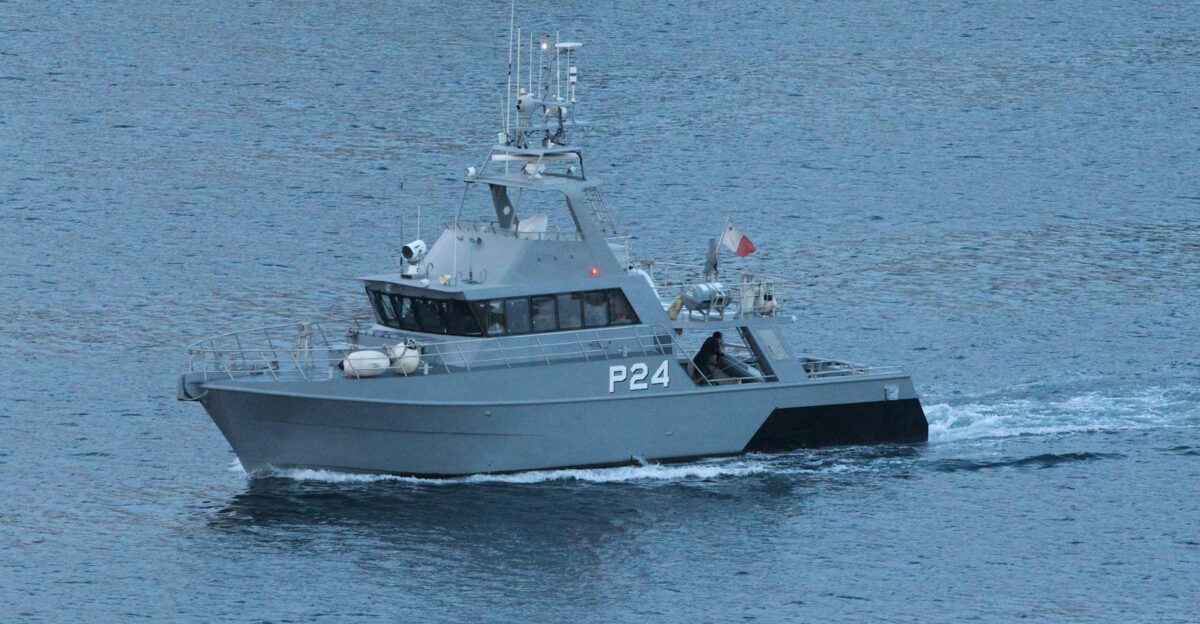 Military patrol boat cruising through ocean waters