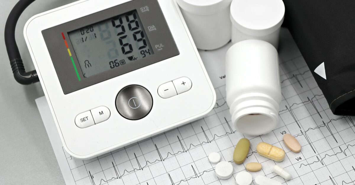 Blood pressure monitor with pills on ECG sheet essential for heart health management