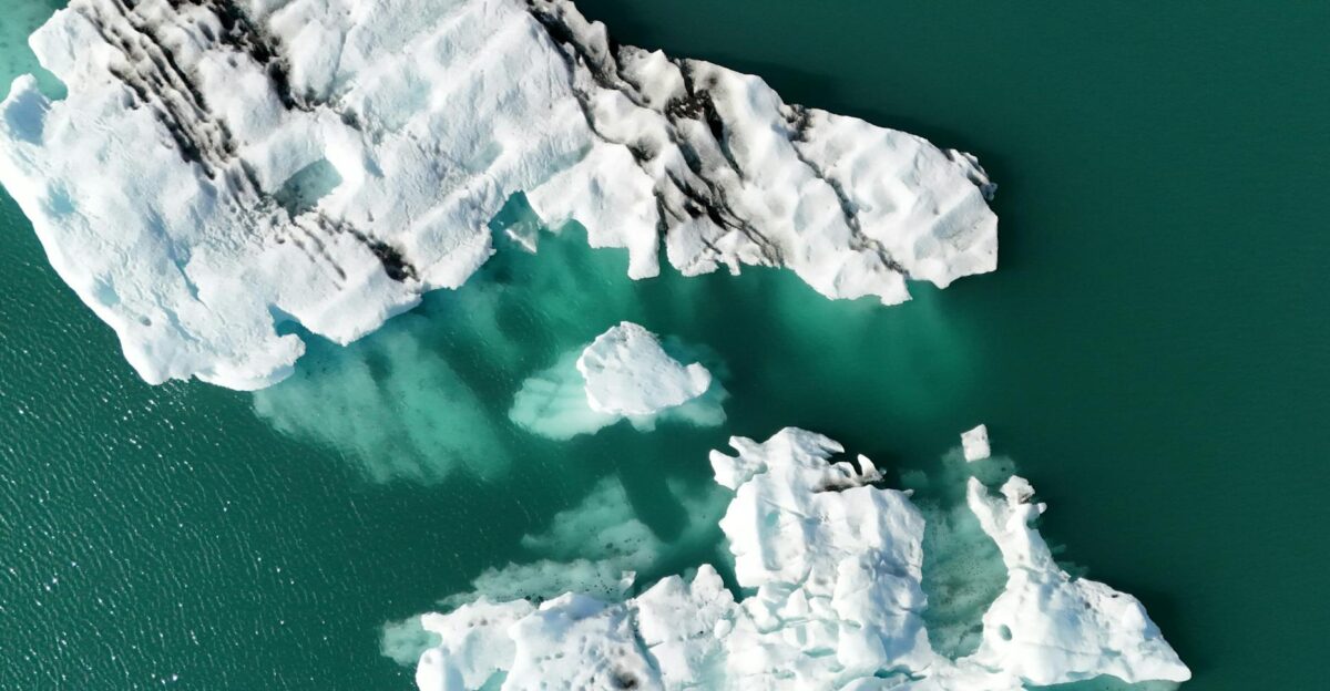 Aerial view of icebergs melting in the turquoise waters of Iceland highlighting climate change impact