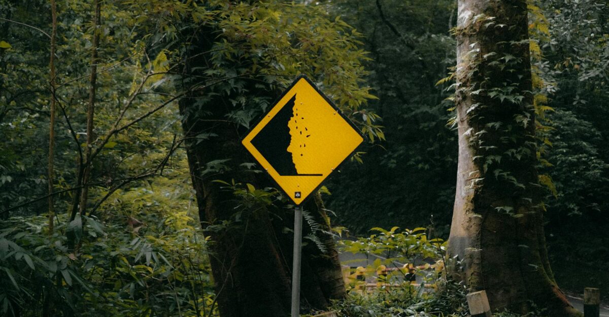 Landslide warning sign in lush green forest Mojokerto East Java