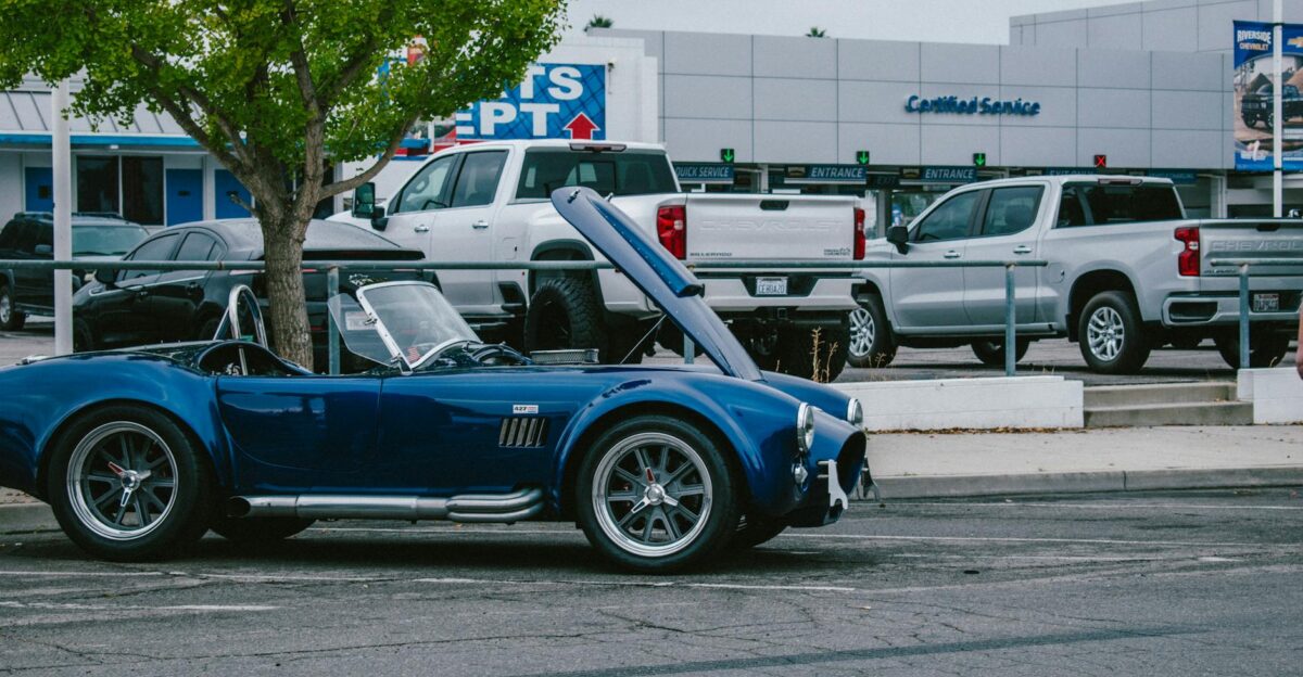 A blue classic Shelby Cobra with its hood open parked in Los Angeles