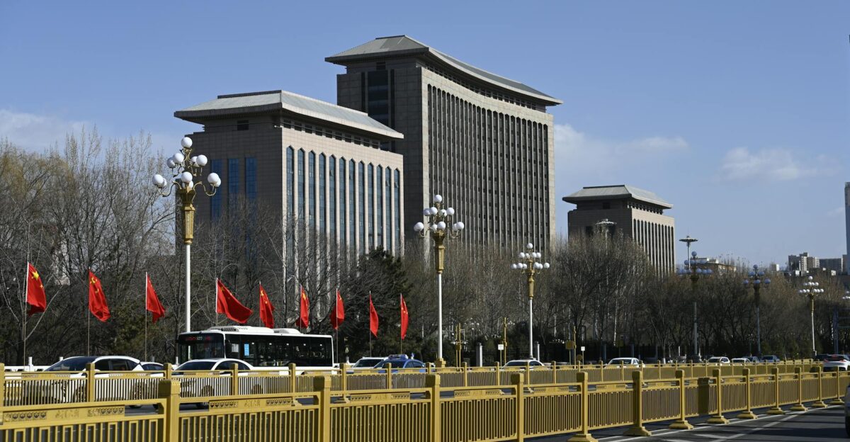 Street view of modern buildings with red flags in Beijing on a clear day