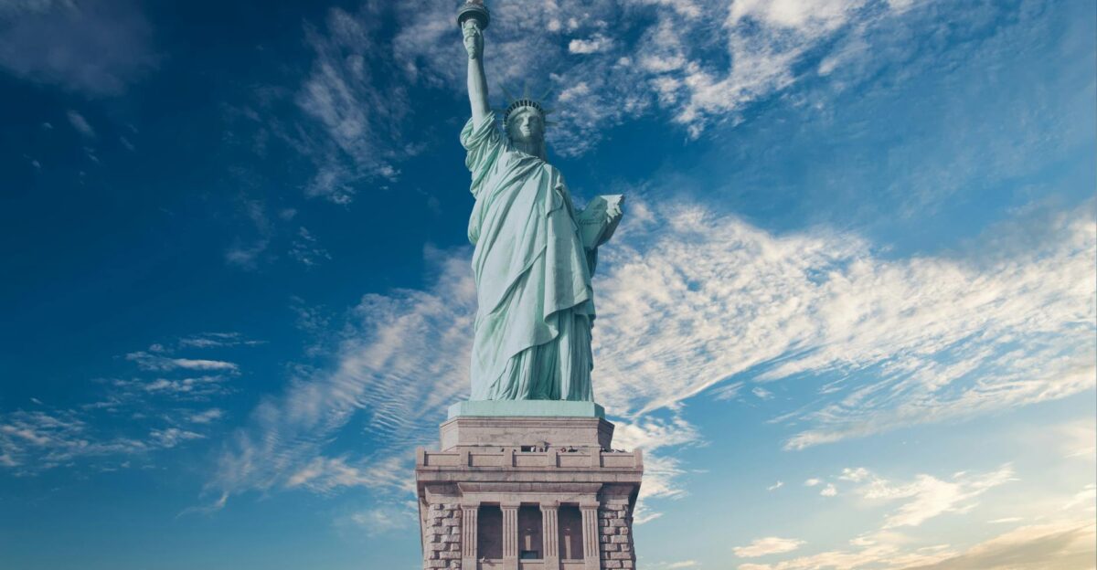 Iconic Statue of Liberty with a backdrop of a vibrant blue sky symbolizing freedom and America