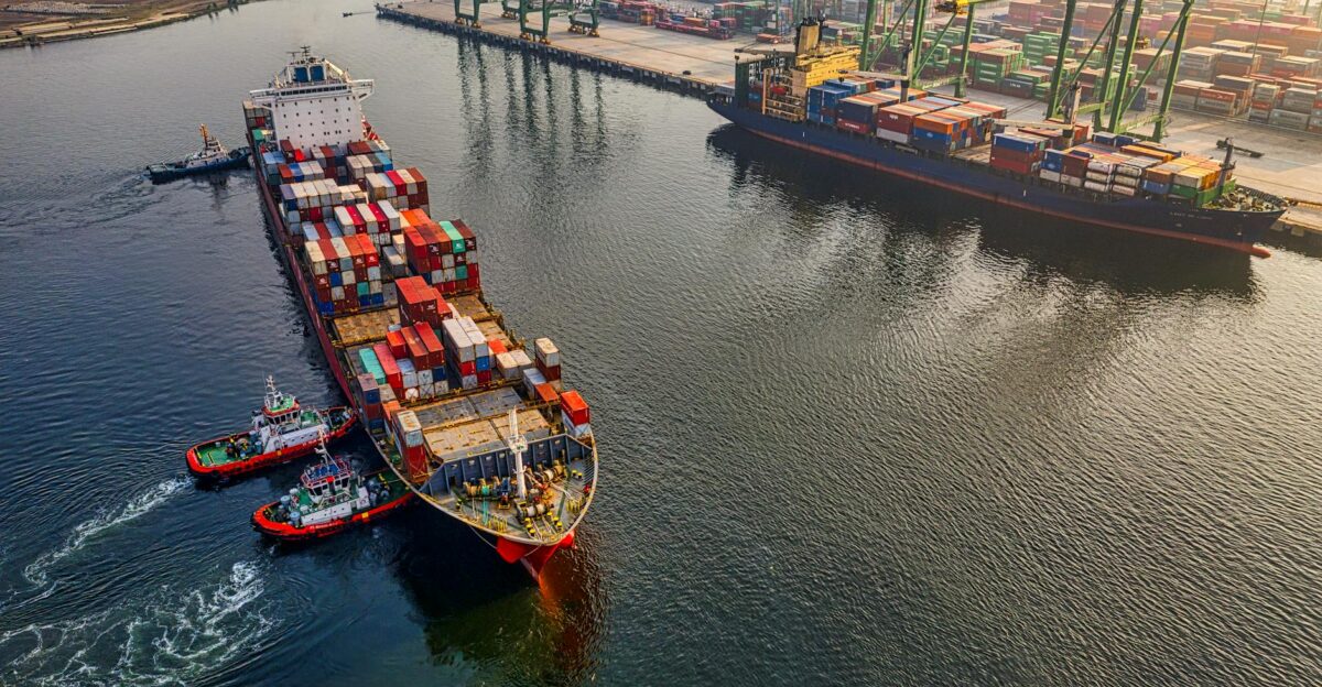 Aerial shot of cargo ships and cranes at North Jakarta port showcasing global shipping and logistics
