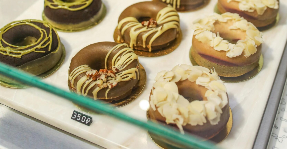 A tempting assortment of gourmet donuts displayed in a bakery. Perfect for food enthusiasts.