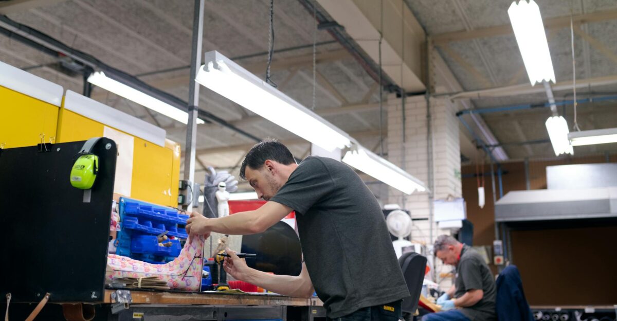 Orthotic technicians skillfully crafting and preparing orthopedic devices in a workshop setting