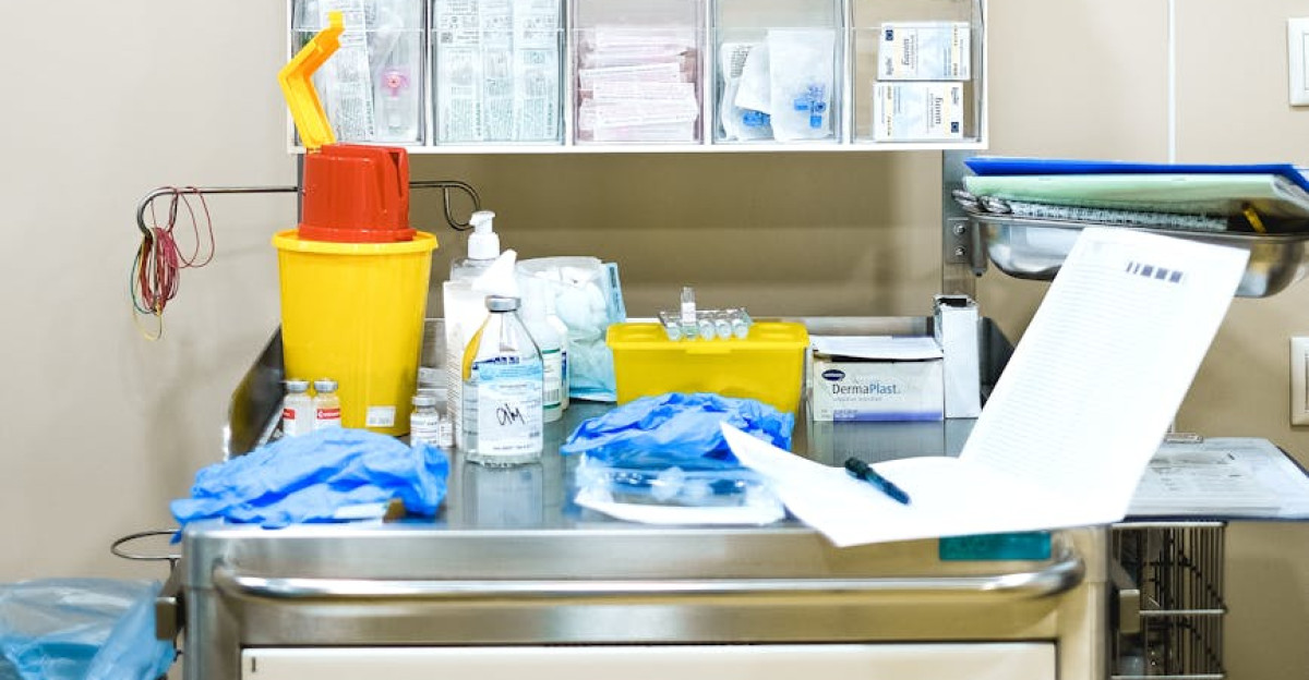 Neatly arranged medical supplies on a shelf in a hospital setting featuring gloves containers and paperwork