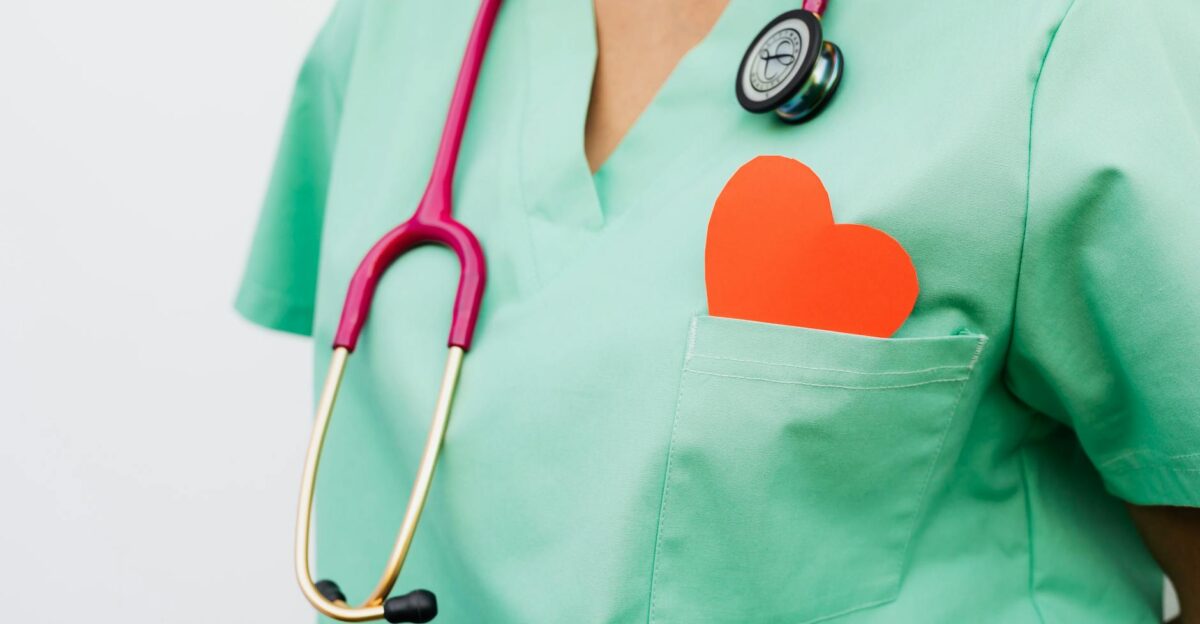 A healthcare professional with a stethoscope and red heart symbol emphasizes cardiology care