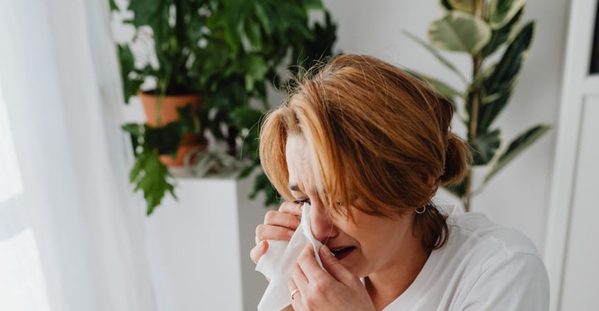 Stressed woman calculating expenses and debt with receipts and bills at home