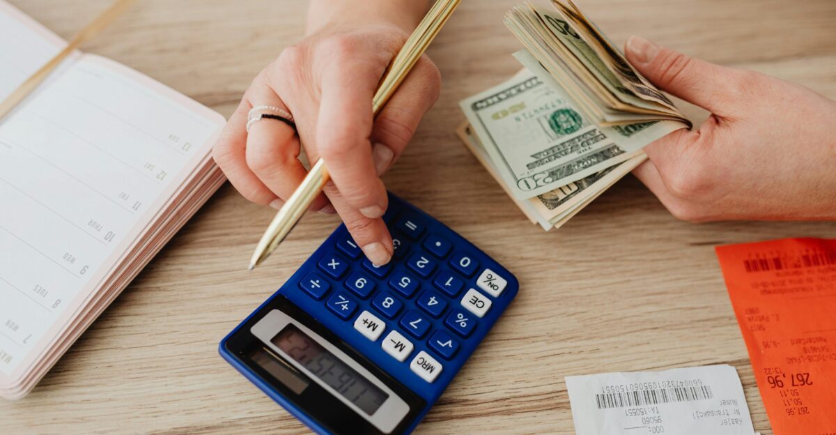 Woman Calculating Money and Receipts Using a Calculator Free