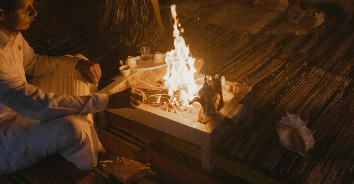 A warm intimate family gathering around a fire sharing stories and meals