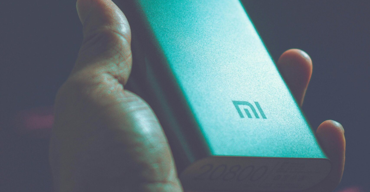 Close-up of a hand holding a Mi power bank, showcasing portable charging technology.