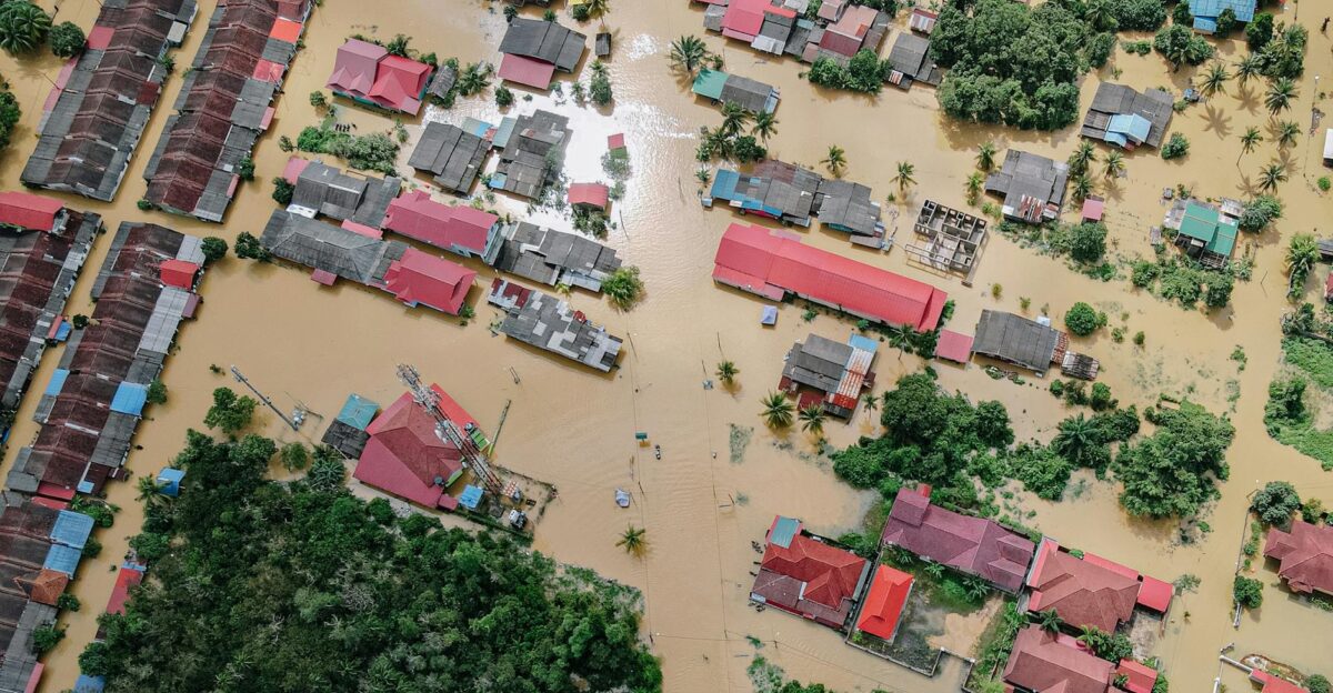 Aerial shot showing a residential neighborhood submerged in floodwater after torrential rains