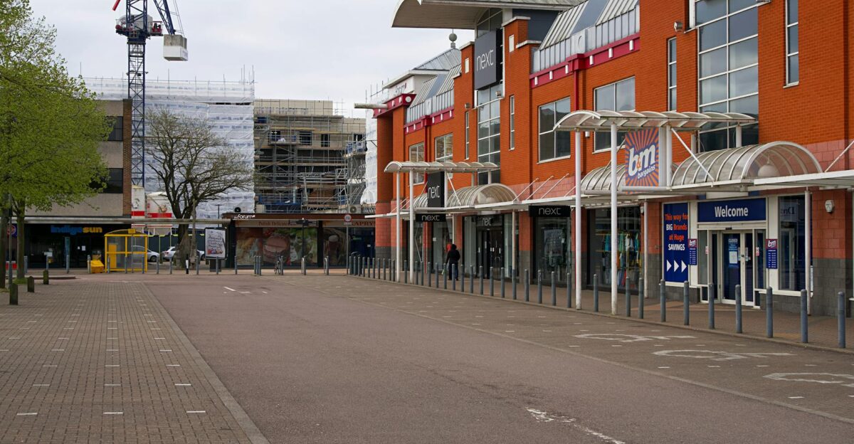 View of a modern shopping center with retail stores on a cloudy day in England highlighting urban architecture