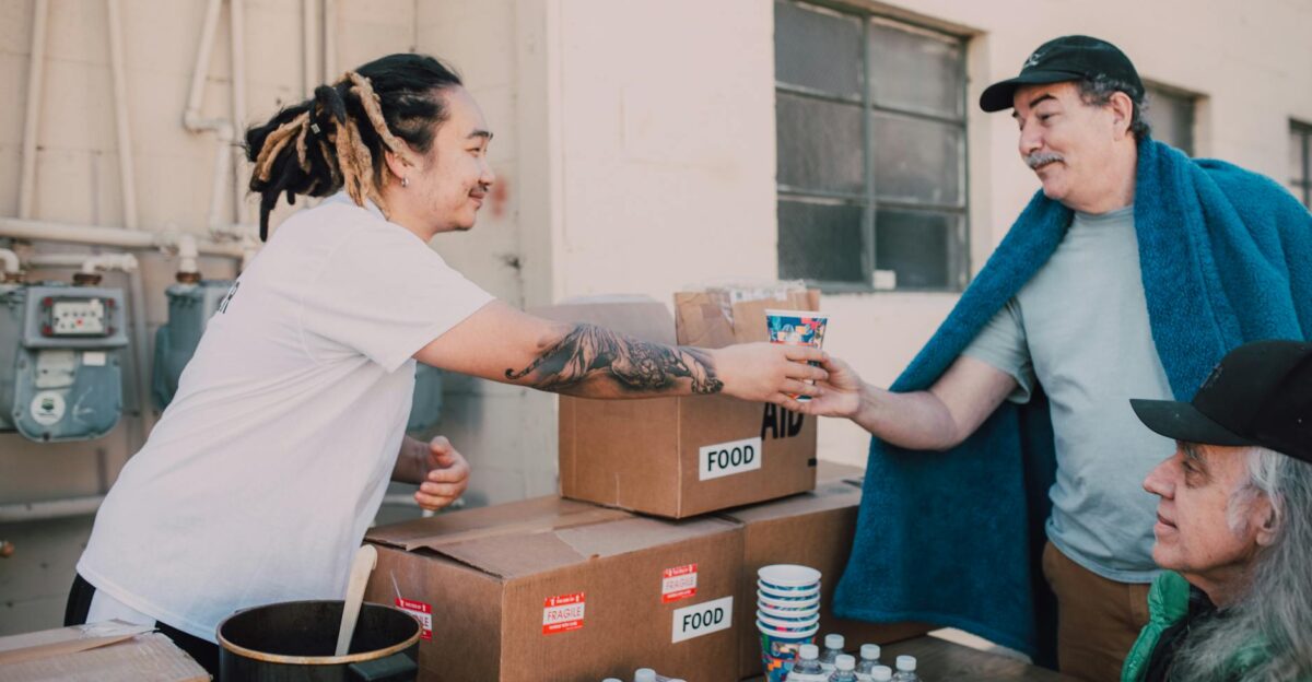 Volunteers distribute food and aid packages to those in need fostering community support