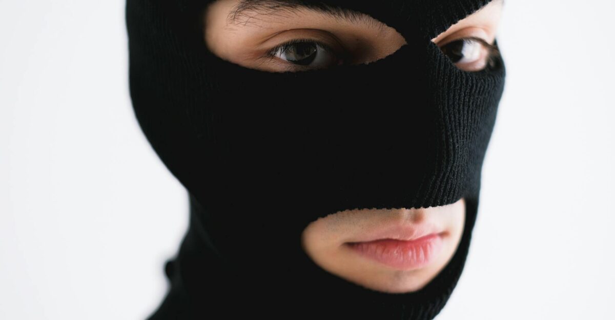 Close-up of a person wearing a black balaclava conveying mystery or anonymity