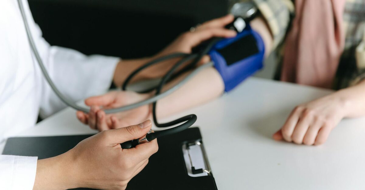 Close-up of a medical professional measuring a patient s blood pressure at a clinic
