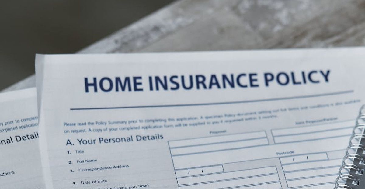 Flatlay image featuring a home insurance policy form and a notebook shot from above