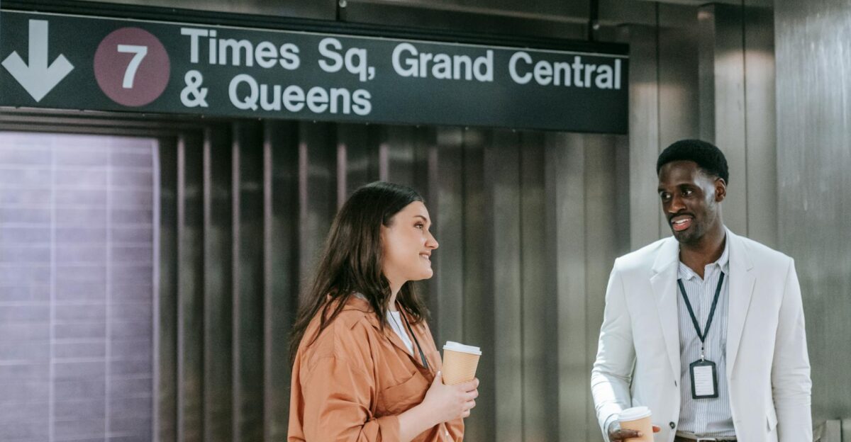 A diverse group of professionals chatting over coffee at Times Square subway station