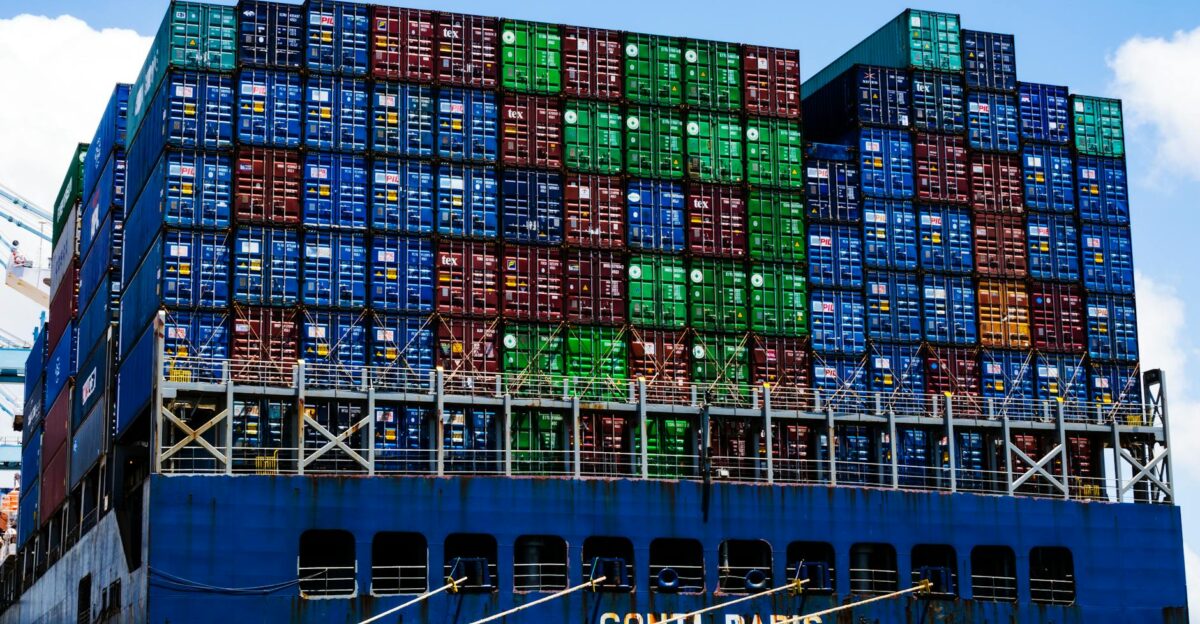 Stacked cargo containers on a massive ship at the harbor symbolizing global trade