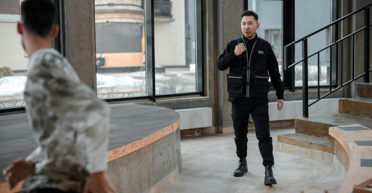 A security guard confronts a fleeing thief in a contemporary indoor setting