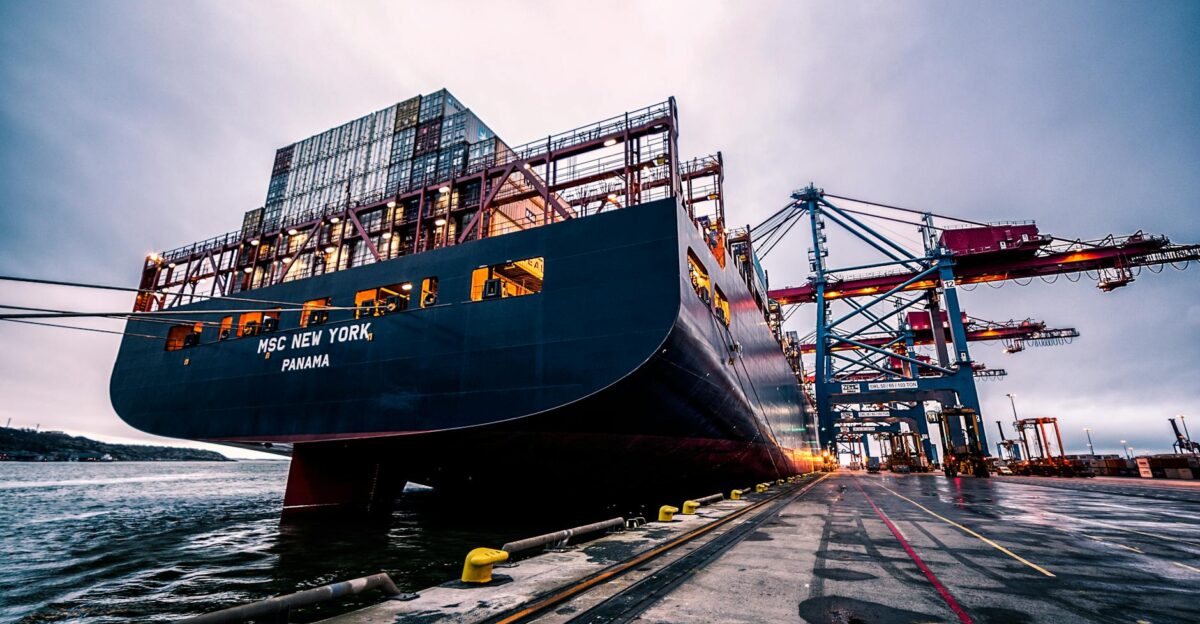A large cargo ship docked at Gothenburg port with industrial cranes Sweden