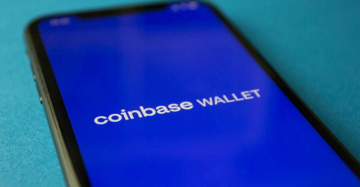 Close-up of a smartphone showing the Coinbase Wallet app interface for cryptocurrency transactions
