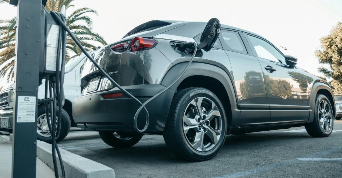 Modern electric vehicle charging at an outdoor station in daylight
